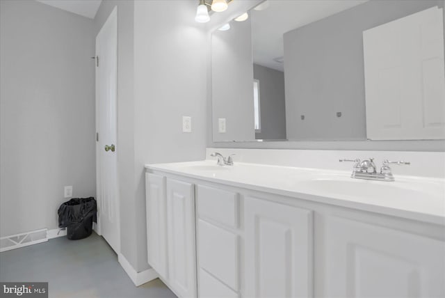 bathroom with concrete flooring and vanity