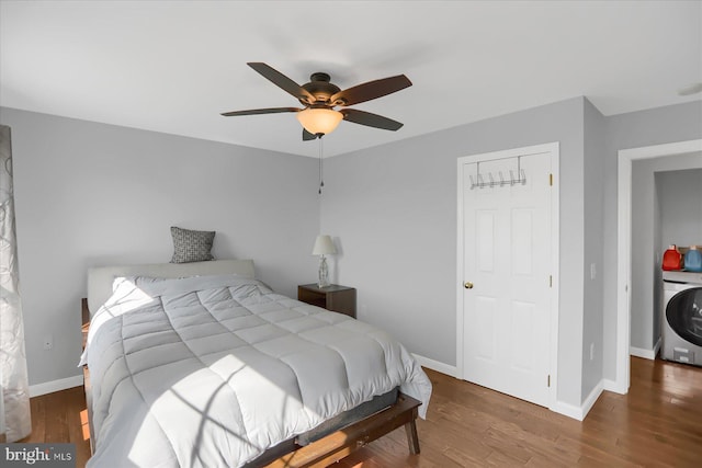 bedroom featuring ceiling fan, hardwood / wood-style flooring, and washer / dryer