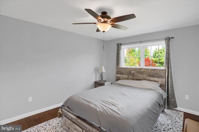 bedroom with dark wood-type flooring and ceiling fan