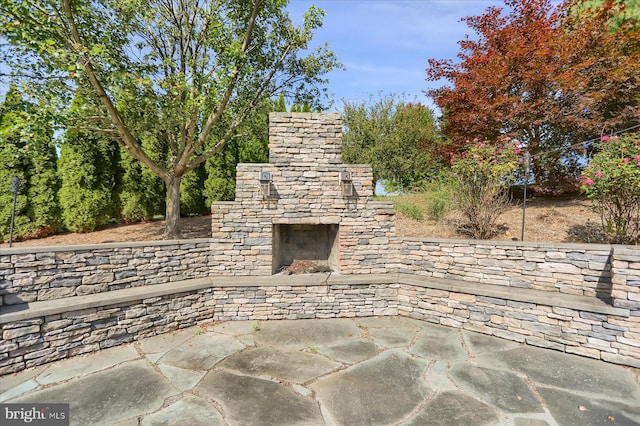 view of patio / terrace with an outdoor stone fireplace