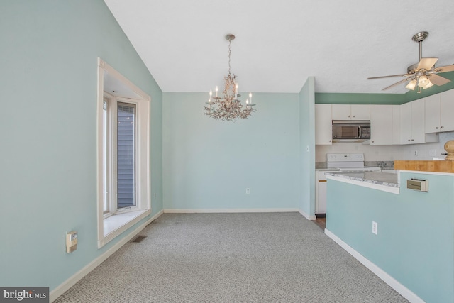 kitchen featuring white range with electric cooktop, hanging light fixtures, white cabinetry, lofted ceiling, and carpet