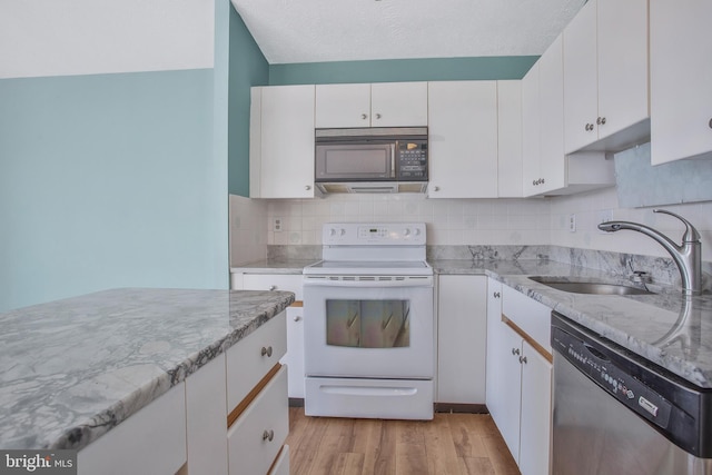 kitchen with light hardwood / wood-style flooring, sink, white range with electric cooktop, stainless steel dishwasher, and white cabinets