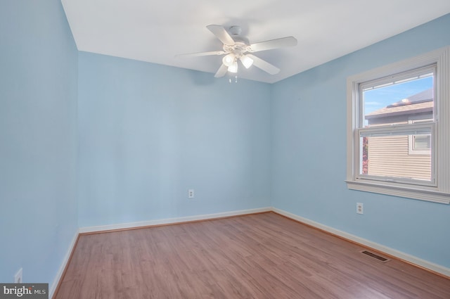 spare room with light hardwood / wood-style flooring and ceiling fan