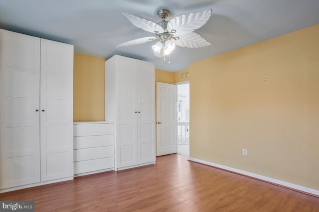 unfurnished bedroom featuring a closet, ceiling fan, and hardwood / wood-style floors