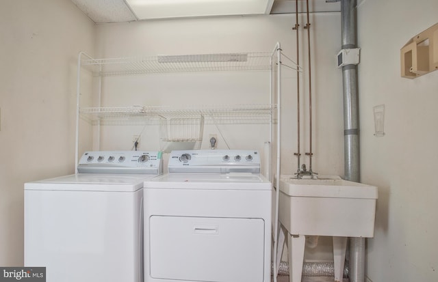 laundry room featuring washer and dryer and sink