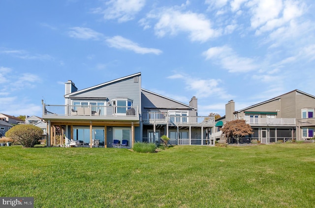 back of property featuring a yard and a deck