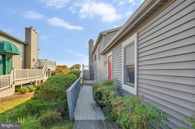 view of property exterior with a wooden deck