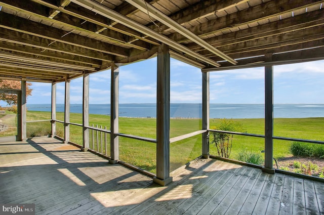 unfurnished sunroom featuring a water view and wooden ceiling