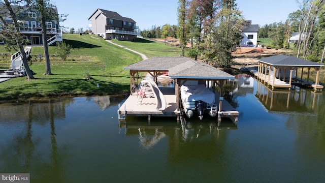 view of dock with a water view and a lawn