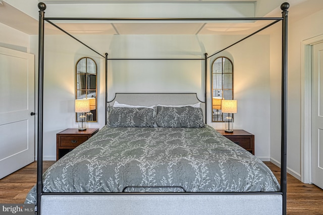 bedroom with dark hardwood / wood-style flooring