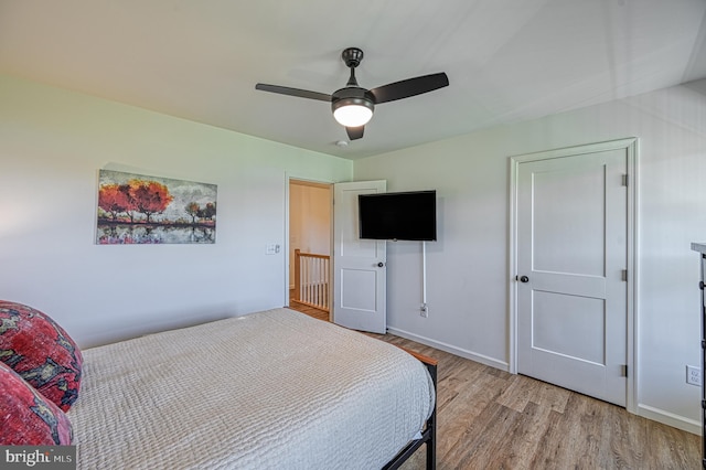 bedroom with light hardwood / wood-style floors and ceiling fan