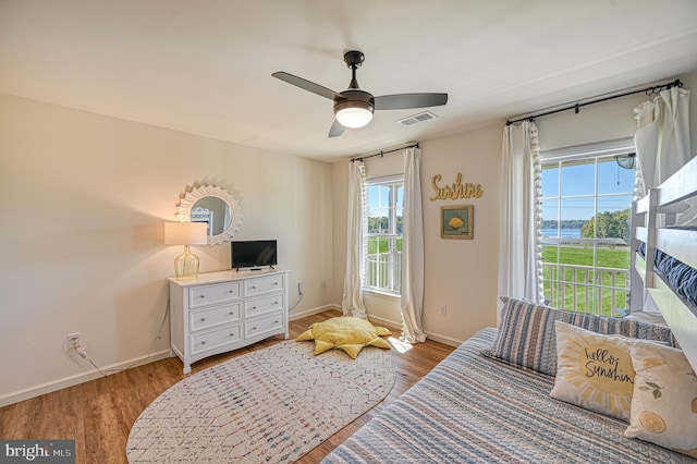 bedroom with ceiling fan and light wood-type flooring