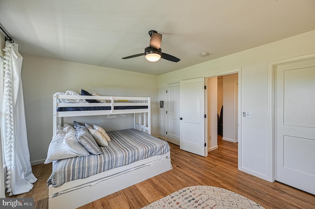 bedroom with hardwood / wood-style flooring and ceiling fan