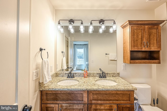 bathroom featuring toilet and vanity