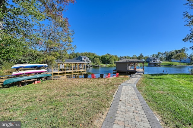 view of dock featuring a yard and a water view