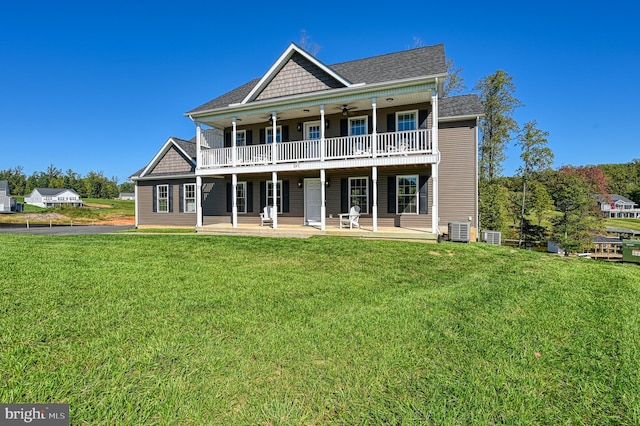 back of property with a patio area, cooling unit, a yard, and a balcony