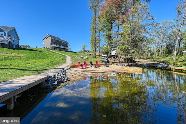 exterior space with a water view and a lawn