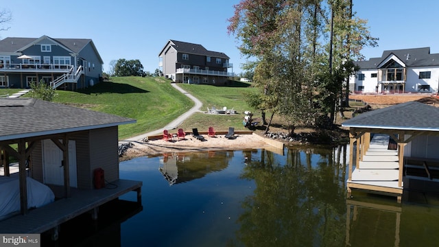 view of dock featuring a yard and a water view