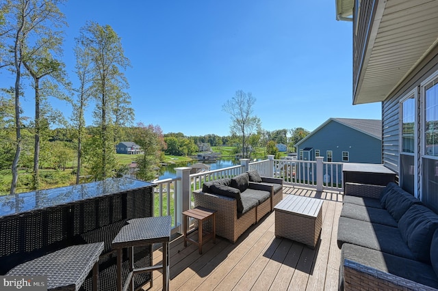 wooden deck featuring outdoor lounge area and a water view