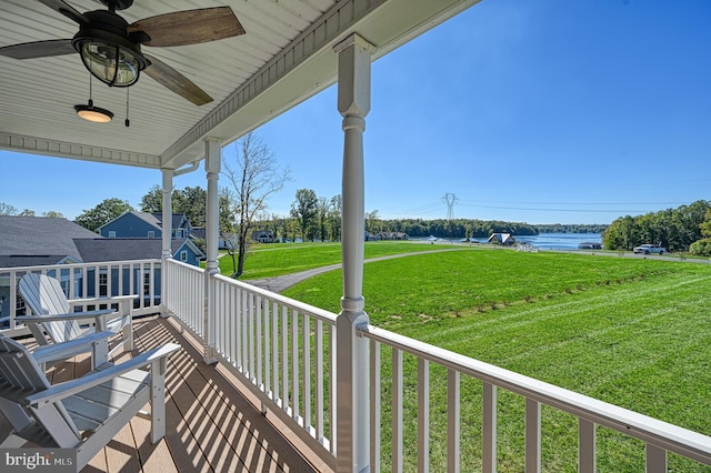 balcony with a water view and ceiling fan