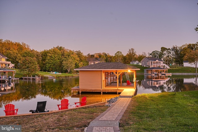 view of dock featuring a water view and a lawn