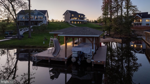 dock area featuring a lawn and a water view