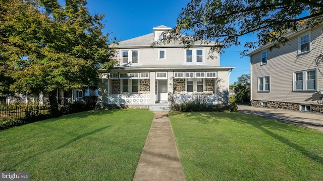 view of front of property with a porch and a front lawn