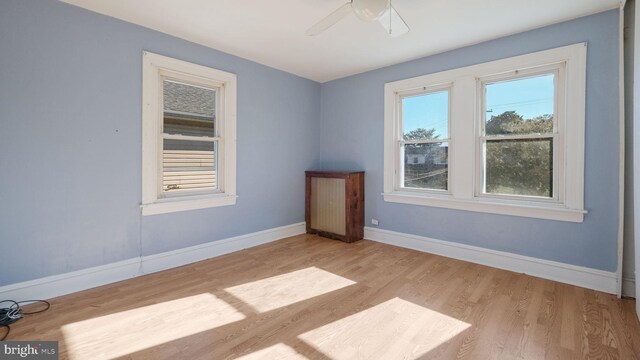 spare room with light hardwood / wood-style flooring and ceiling fan