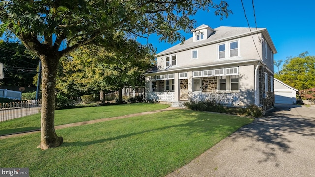 view of front of home with a garage, a porch, and a front lawn