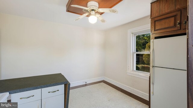 interior space with ceiling fan