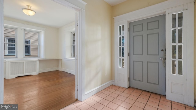 entryway featuring radiator and light hardwood / wood-style flooring