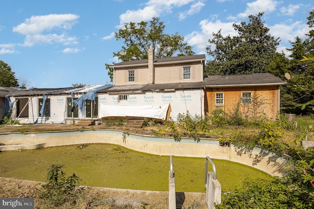 back of house with a lawn and a patio area