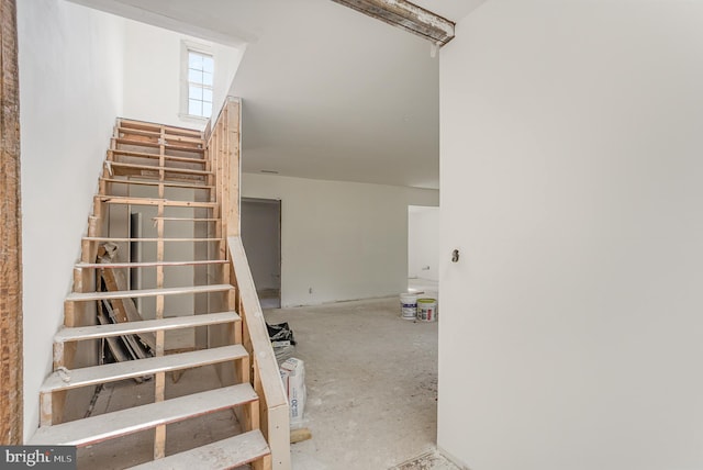 staircase featuring concrete floors