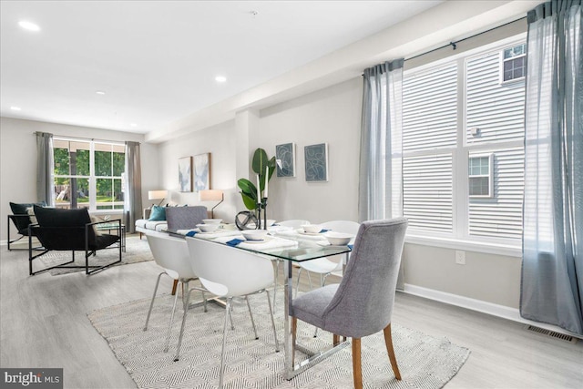 dining space with light hardwood / wood-style floors