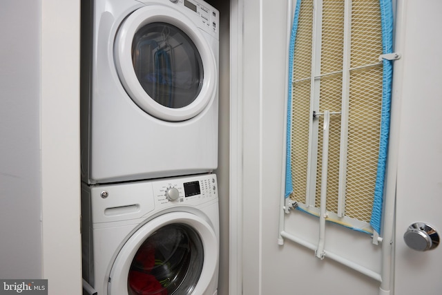 clothes washing area featuring stacked washer / drying machine