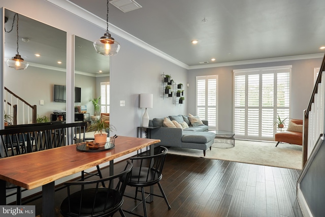 dining area with ornamental molding and dark wood-type flooring