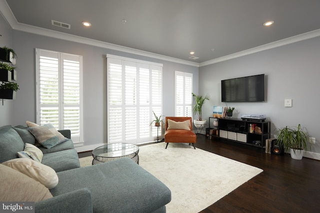 living room featuring crown molding, dark hardwood / wood-style flooring, and a healthy amount of sunlight