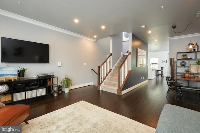 living room with crown molding and dark hardwood / wood-style floors