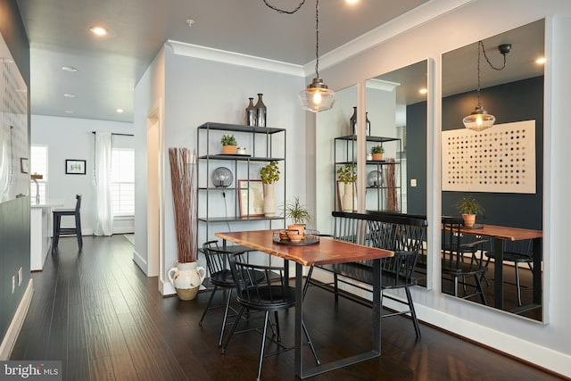 dining space with ornamental molding and dark hardwood / wood-style flooring