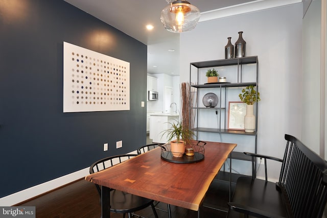 dining space featuring wood-type flooring