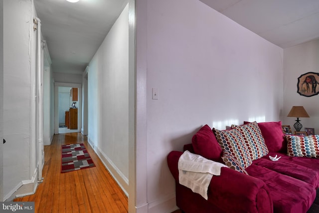 living area with light wood-style flooring and baseboards