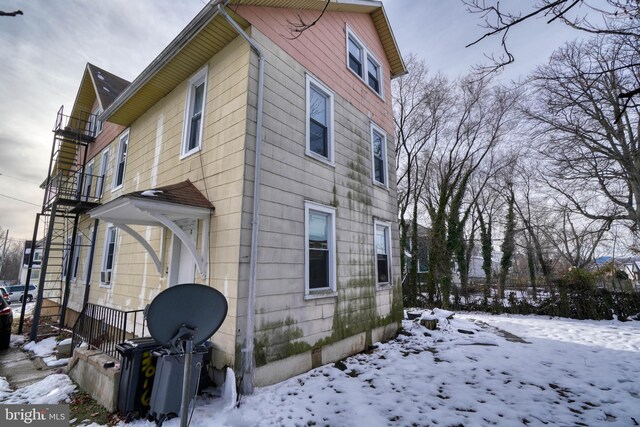view of snow covered exterior featuring a balcony