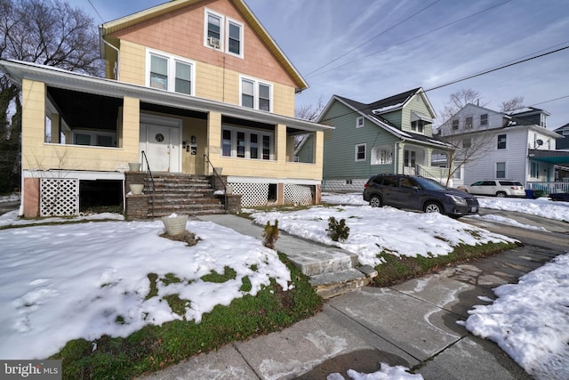 american foursquare style home with a porch