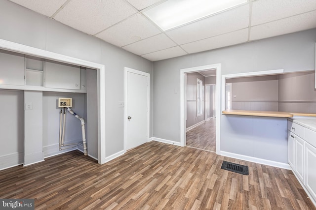 laundry area featuring cabinets and dark wood-type flooring