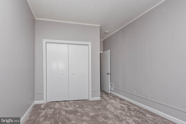 unfurnished bedroom with light carpet, a closet, and ornamental molding