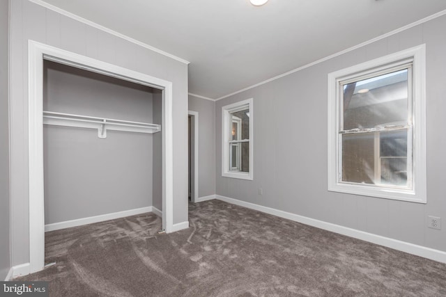 unfurnished bedroom featuring a closet, dark carpet, and ornamental molding