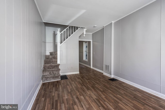 interior space with dark hardwood / wood-style flooring and crown molding