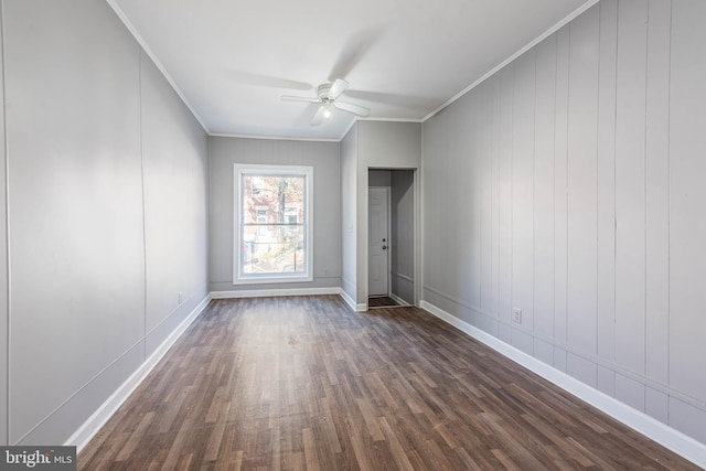 unfurnished bedroom with ceiling fan, dark hardwood / wood-style floors, and ornamental molding