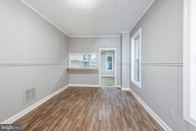 interior space with dark wood-type flooring and crown molding