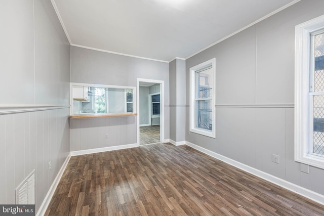 unfurnished room featuring hardwood / wood-style floors and ornamental molding